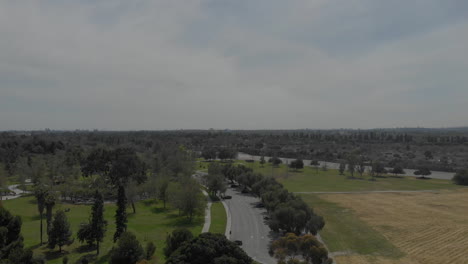 Drone-ascends-over-Southern-CA-park-suburbs