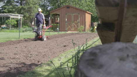 Older-gentleman-prepares-his-garden-for-the-Spring-by-tilling-the-soil