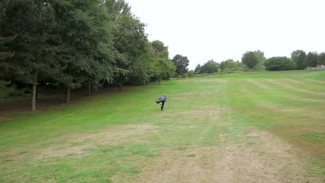 Wide-shot-of-a-golfer-walking-towards-the-green-after-a-shot