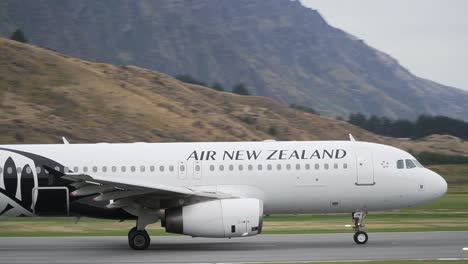 Commercial-plane-taking-off-from-Queenstown-Airport,-New-Zealand-with-mountains-in-background