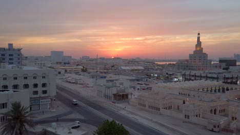 Sunset-sky-line-of-Doha-Qatar,-with-views-of-"Abdulla-Bin-Zaid-Al-Mahmoud-Islamic-Cultural-Center"-also-knowen-as-"Bin-Zaid",-filmed-in-4k-from-a-high-building