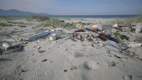 Reveal-shot-of-Plastic-Waste-and-Trash-on-White-Sandy-Beach