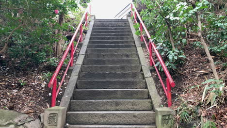 An-Asian-stone-staircase-with-red-rails-at-Inokashira-Park
