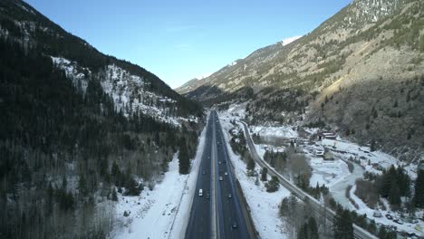 Surreal-aerial-clip-of-the-Interstate-cutting-through-the-Colorado-Mountains-and-the-town-of-Idaho-Springs