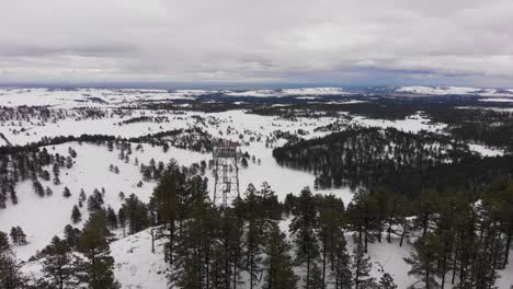 Wilderness-Firetower-on-top-of-a-mountain-in-the-snow-Aerial