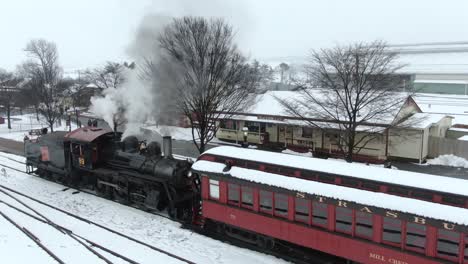 Aerial-conductor-stands-by-the-restored-steam-engine-Strasburg-Railroad-Ronks,-Pennsylvania-Concept:-transportation,-railroads,-Americana,-nostalgia,-traditional,-winter,-Polar-Express