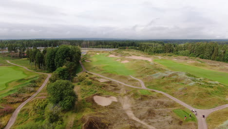 Aerial-flyover-of-green-golf-course-in-Sweden-at-daytime