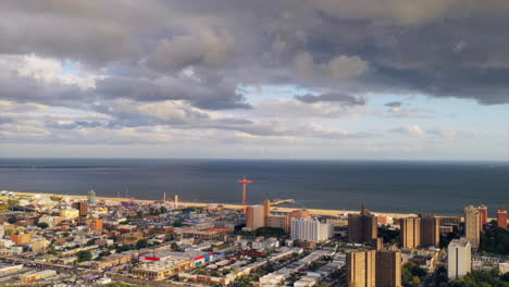 a-time-lapse-video-over-Coney-Island-Creek,-looking-at-the-parachute-drop-at-Coney-Island-Park-in-the-distance---the-Coney-Island-Channel-on-the-horizon