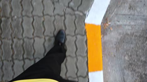 Slowmotion-view-of-the-man-while-walking-on-the-foot-path