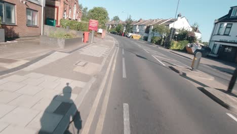 Commuter-cycling-with-a-helmet-mounted-action-camera-on-Pinner-Road,-Harrow,-Middlesex