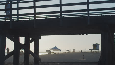 A-small-child-runs-under-a-silhouetted-pier