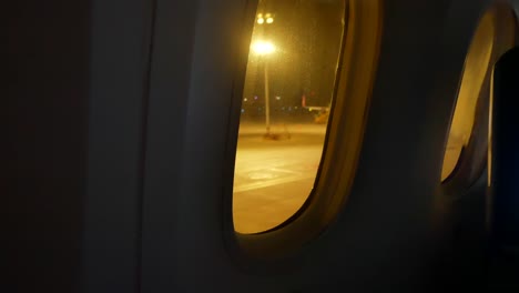 video-from-inside-the-plane-through-the-windows-of-aircraft-while-taxiing-on-taxi-way-in-the-evening-flight-time