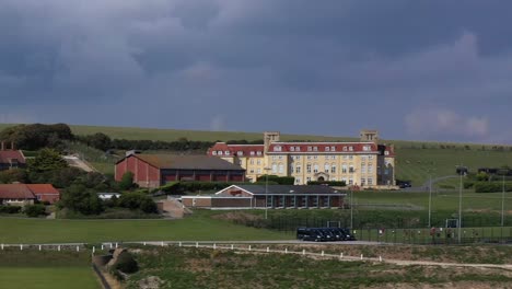Tight-aerial-profile-view-of-Roedean-School,-situated-on-the-Chalk-cliffs-near-Brighton,-UK
