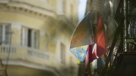 day-shot-close-up-of-typical-balcony-at-Havana-Cuba-with-colorful-clothes-hanging-waving-in-the-wind-yellow-building-at-background-fresh-clean-feeling-sunny-day
