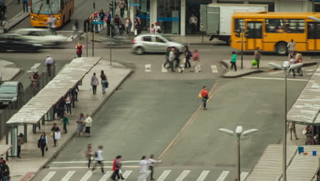 Time-lapse-of-bus-stop-with-many-people-and-traffic-of-buses,-Curitiba,-Parana,-Brazil
