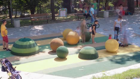Children-and-parents-having-fun-on-playground-in-park
