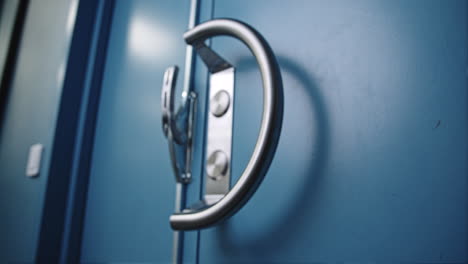 Slow-pull-in-of-blue-industrial-door-with-big-door-handle