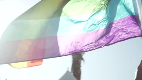 Slow-Motion-Close-Up-Shot-of-Pride-Flag-Waving-in-Air-at-River-City-Pride-Parade-in-Jacksonville,-FL