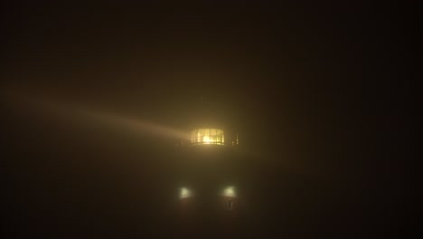 Lighthouse-in-dense-fog-with-large-beams-penetrating-through-the-mist