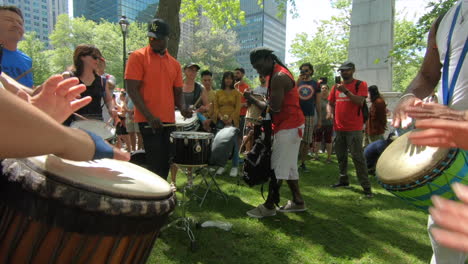 Percussion-performers-outside-in-park,,-musicians,-band-playing-percussion,-drum-instruments,-rhythm-art,-outside-festival,-tabla,-beat-drummers,-tambourine,-drums-performance