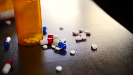 Prescription-drug-pills,-narcotic-tablets,-pain-killers-and-pharmacy-bottles-on-a-table