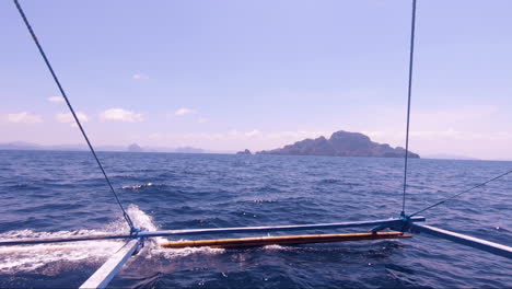 Slow-motion-pan-from-left-to-right-showing-the-beautiful-ocean-and-landscape-of-El-Nido-on-a-perfect,-unique-and-extraordinary-day-trip-on-a-traditional-boat