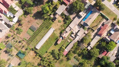 Aerial-Drone-Birds-Eye-Footage-of-Village-with-green-house-agriculture-industry