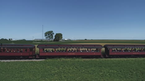 Aerial-View-of-a-Thomas-the-Tank-Engine-with-Passenger-Cars-Puffing-along-Amish-Countryside