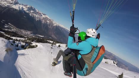 Aerial-moving-shot,-tandem-Paragliding-above-the-Madonna-DI-Campiglio,-scenic-view-of-the-mountains-in-Italy