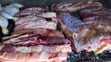 Close-up-shot-of-raw-Argentinian-barbecue-or-adado-over-smoky-grill