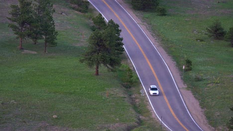 Aerial-view-of-automobile-going-downhill-in-mountain-roads