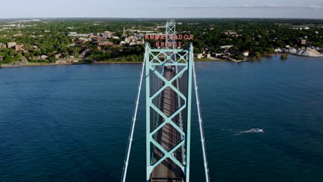 Aerial-footage-approaching-the-Ambassador-Bridge-in-Detroit,-Michigan-at-sunset