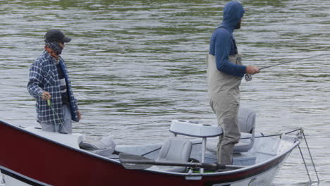 Rack-focus-tilt-up-reveal-of-two-friends-flyfishing-on-Snake-River-Chester-Idaho