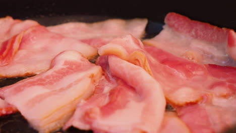 Close-up-of-frying-bacon-in-a-pan