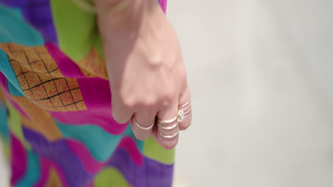 Female-Hand-Touches-Colorful-Dress-on-Sunny-Day,-Slow-Motion,-Close-Up