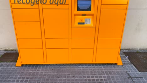 Amazon-hub-Locker-pick-up-point-in-Spain,-tilting-up-4K