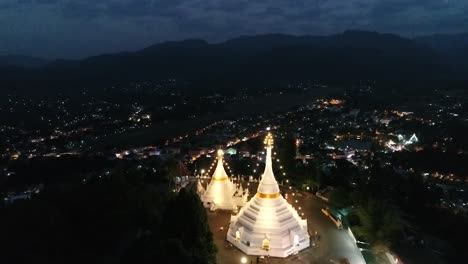 Aerial-Footage-Night-Time-of-Phra-That-Doi-Kong-Moo,-Buddhism-Temple-which-is-the-Landmark-of-Mae-Hong-Son,-the-Northern-of-Thailand