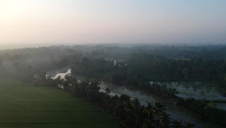 Sunrise-in-a-paddy-field-village,sky,Sun-beam-reflection-,River,Aerial-Shot,irrigation,Mist,Mangroves,Water,Asia