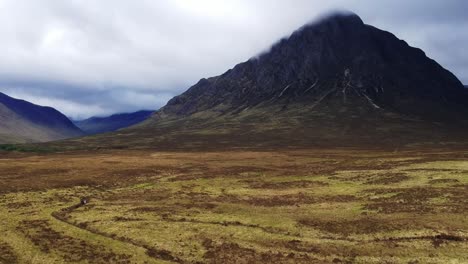 Tilt-down-drone-shot-of-scottish-highland-mountain-valley-landscape