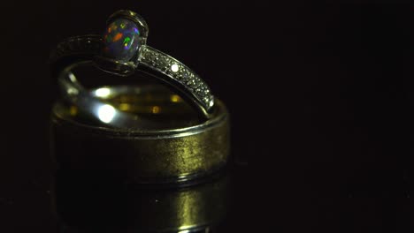 Wedding-rings,-engagement-on-top-on-man's-wedding-ring-with-light-motion-4K