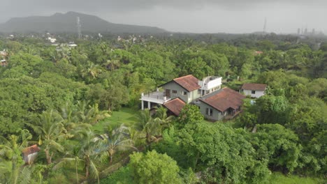Circular-drone-shot-of-large-holiday-home-with-swimming-pool-Indian-countryside
