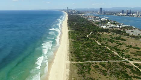 Distant-view-of-waves-slowly-rolling-to-the-perfect-beaches-of-Surfers-Paradise,-Gold-Coast,-Queensland-,-Australia