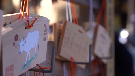 Typical-wooden-wishing-cards-at-Japanese-shrine-with-year-of-the-cow-zodiac-sign-low-depth-of-field