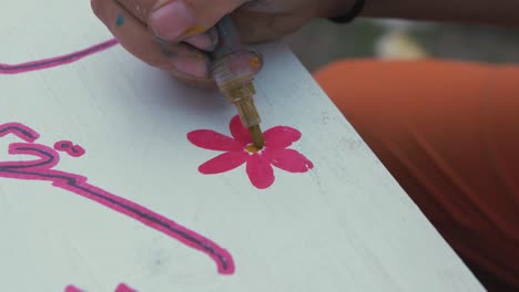 Drawing-flower-finishing-touches-on-sign