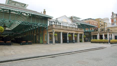 Lockdown-in-London,-slow-motion-gimbal-pan-of-empty-Covent-Garden-Piazza-and-Apple-Market,-West-End,-with-no-people,-during-the-COVID-19-pandemic-2020