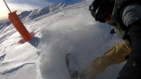 Man-snowboarding-in-fresh-powder-snow-downhill-steep-ski-slope,-selfie