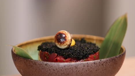 Plating-Delicious-Raw-Tuna-Topped-With-Black-Sushi-Caviar-Using-A-Stainless-Steel-Food-Ring-Mold---close-up