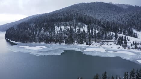 Montaña-Del-Bosque-Invernal-Con-Lago-Congelado---Toma-Aérea-De-Drones