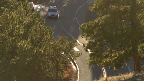 Aerial-view-of-car-driving-in-the-mountains