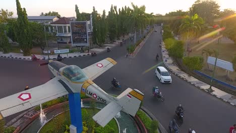 Airplane-monument-and-fountain-by-airport-in-Mataram-City-Indonesia,-aerial-view